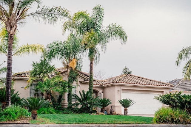 mediterranean / spanish-style house featuring a garage