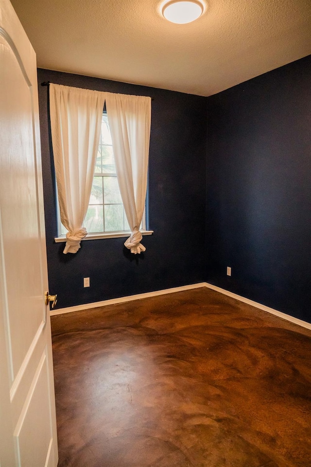 spare room with a textured ceiling