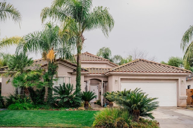 mediterranean / spanish-style house with a garage