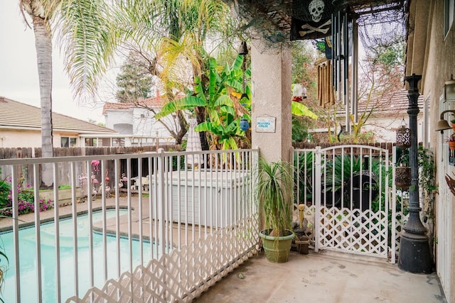 view of gate featuring a community pool