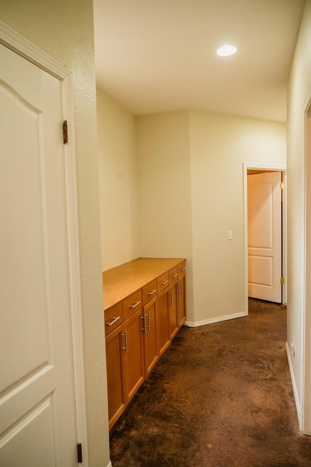 corridor with dark colored carpet