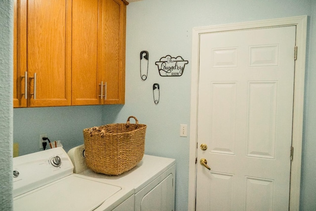 laundry area featuring cabinets and separate washer and dryer