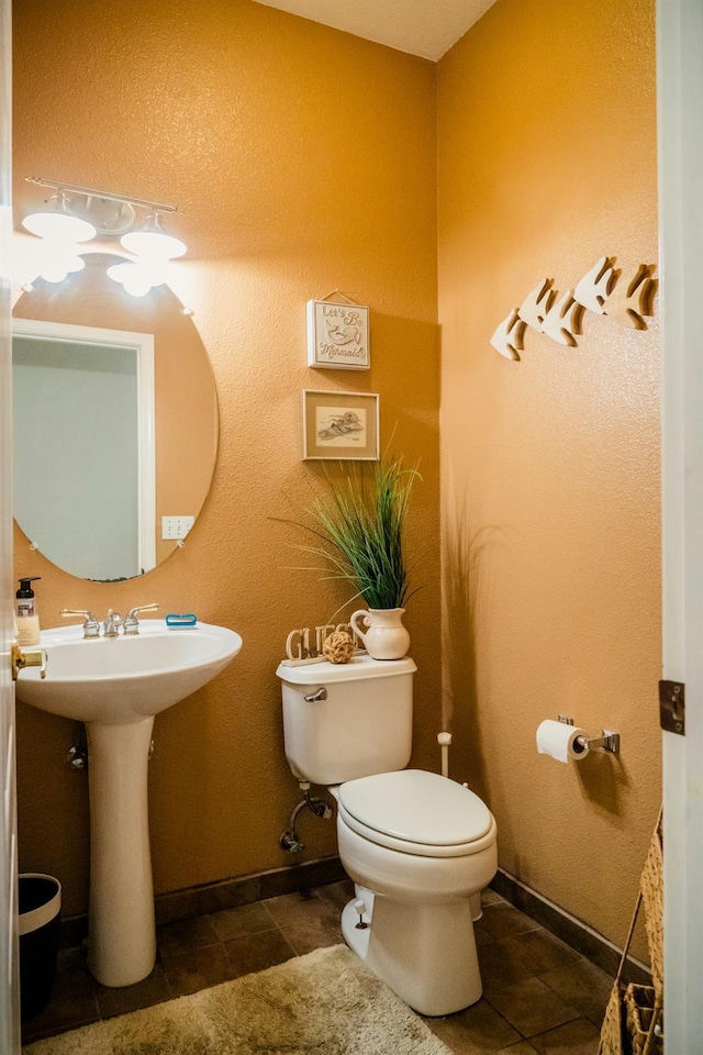 bathroom with sink, tile patterned flooring, and toilet