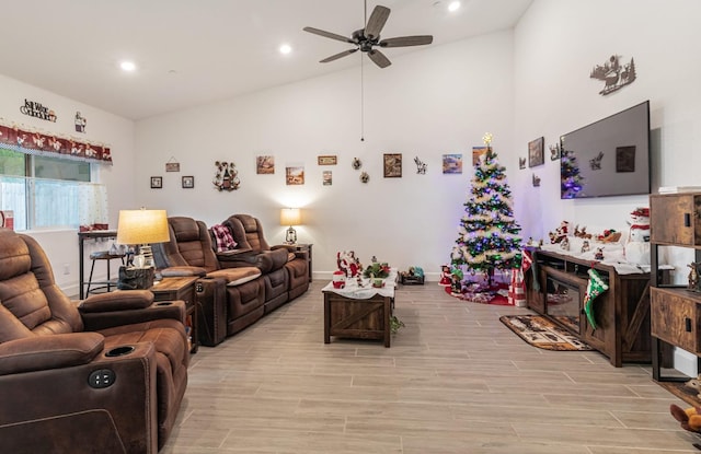 living room with ceiling fan and vaulted ceiling