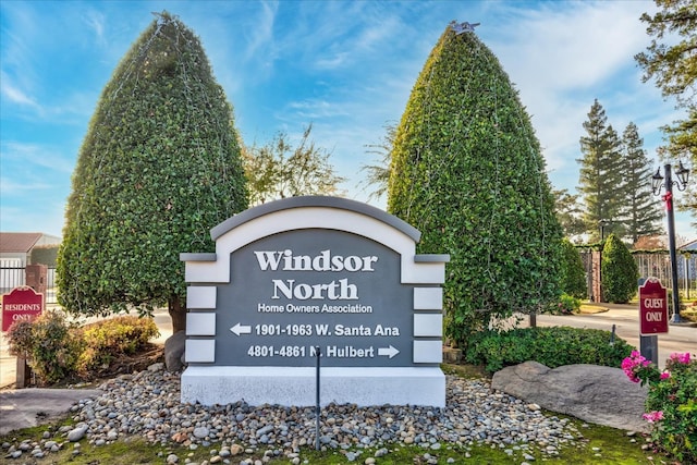 community / neighborhood sign with fence