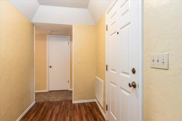 corridor featuring dark hardwood / wood-style flooring and lofted ceiling