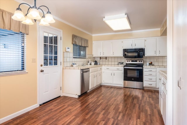 kitchen featuring stainless steel appliances, tile counters, white cabinetry, and crown molding