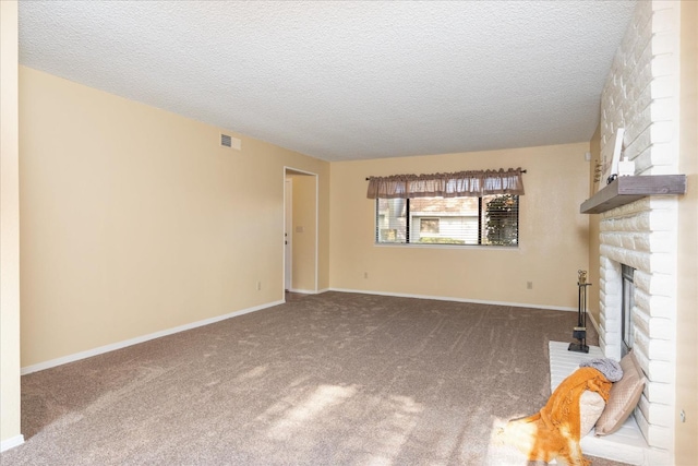 unfurnished living room with a fireplace, visible vents, carpet flooring, a textured ceiling, and baseboards