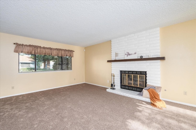 unfurnished living room with carpet, a brick fireplace, a textured ceiling, and baseboards