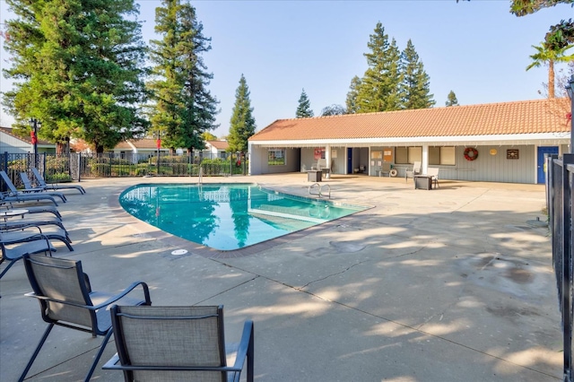 community pool featuring a patio area and fence