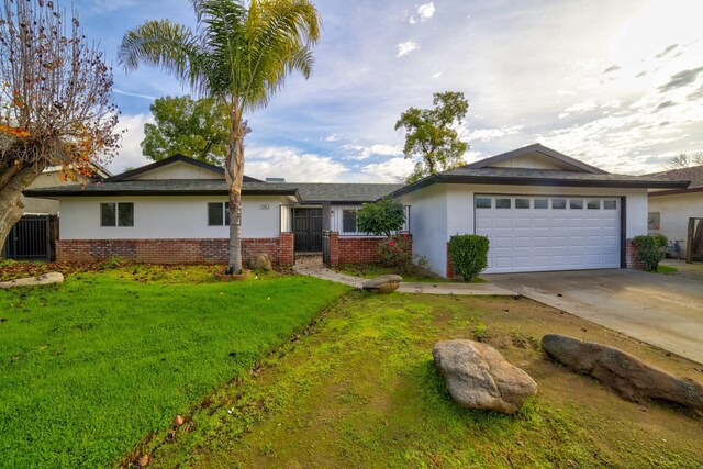 ranch-style home with a front yard and a garage