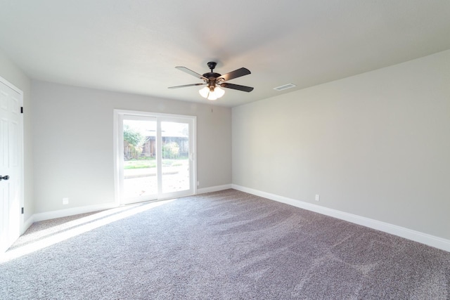 carpeted empty room featuring visible vents, baseboards, and a ceiling fan