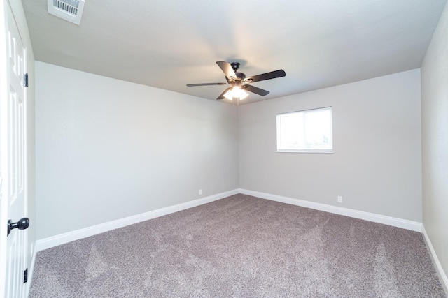 carpeted empty room with a ceiling fan, visible vents, and baseboards