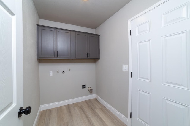 washroom featuring cabinets, hookup for a washing machine, and light hardwood / wood-style floors