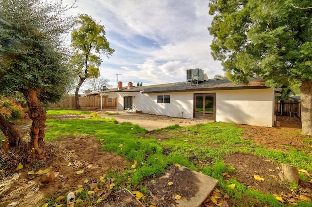 rear view of house featuring cooling unit and a patio area