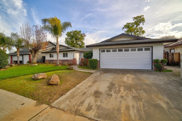 single story home with a front lawn and a garage