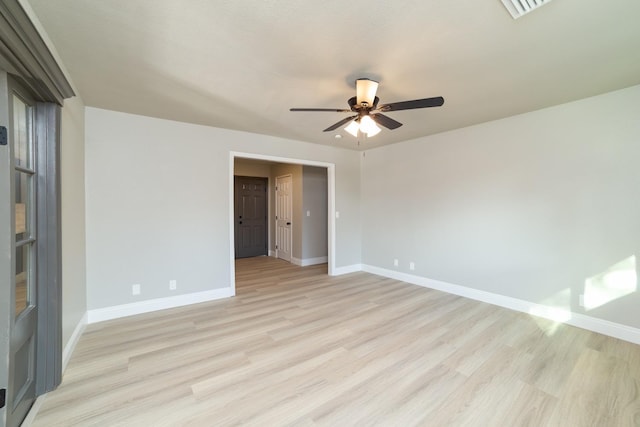 empty room with light hardwood / wood-style flooring and ceiling fan