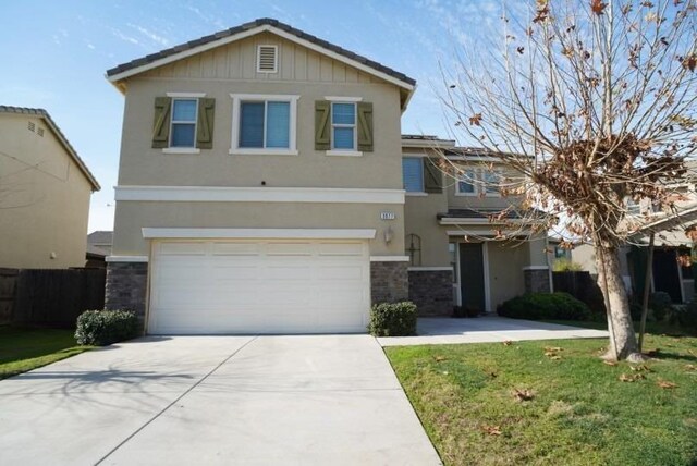 view of front of home featuring a garage and a front lawn