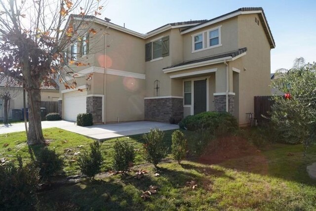 back of house with a lawn and a garage