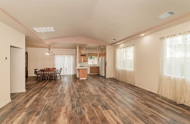 living room featuring lofted ceiling and dark hardwood / wood-style flooring