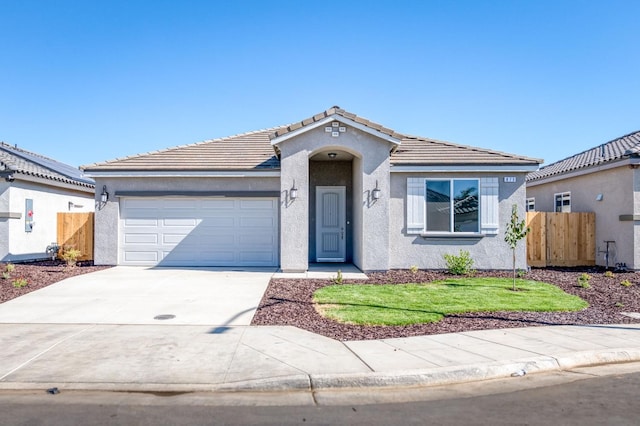 view of front of property with a front lawn and a garage