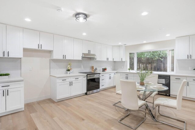 kitchen featuring stainless steel electric stove, light hardwood / wood-style floors, white cabinets, and tasteful backsplash