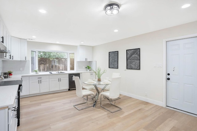 dining room with sink and light hardwood / wood-style floors