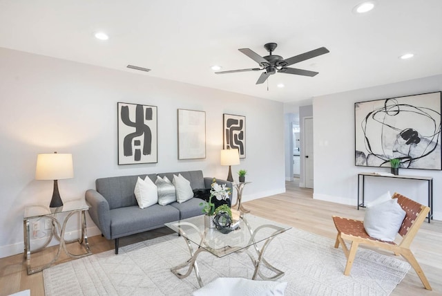 living room with light wood-type flooring and ceiling fan