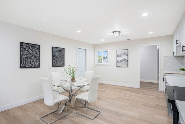 dining space featuring light hardwood / wood-style floors