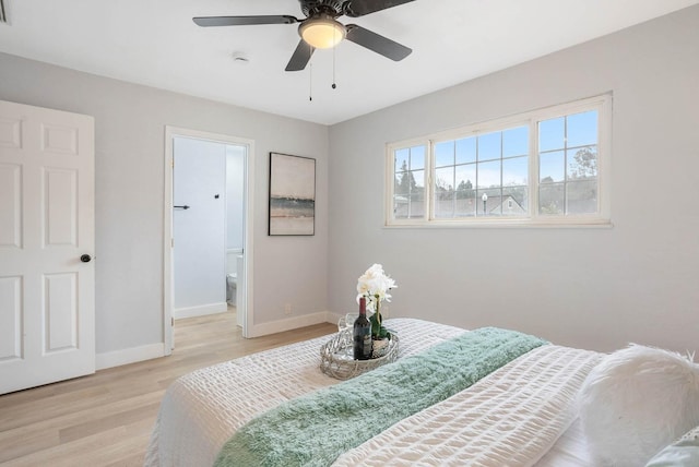 bedroom with ceiling fan, ensuite bath, and light hardwood / wood-style flooring