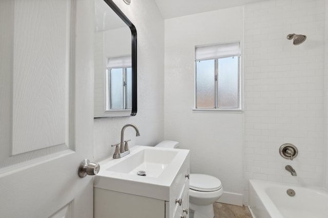 full bathroom with vanity, toilet, and tiled shower / bath