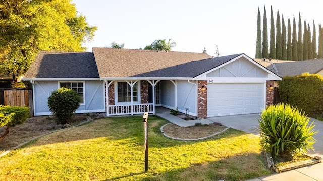 single story home featuring covered porch, a garage, and a front yard