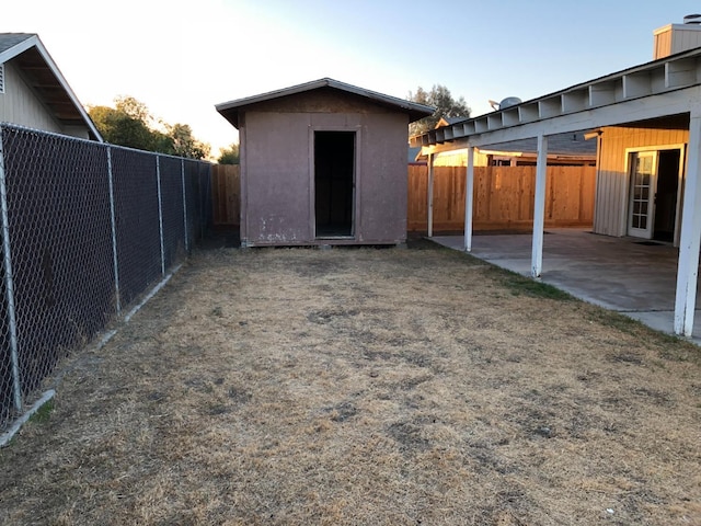 view of yard with a patio and a storage shed