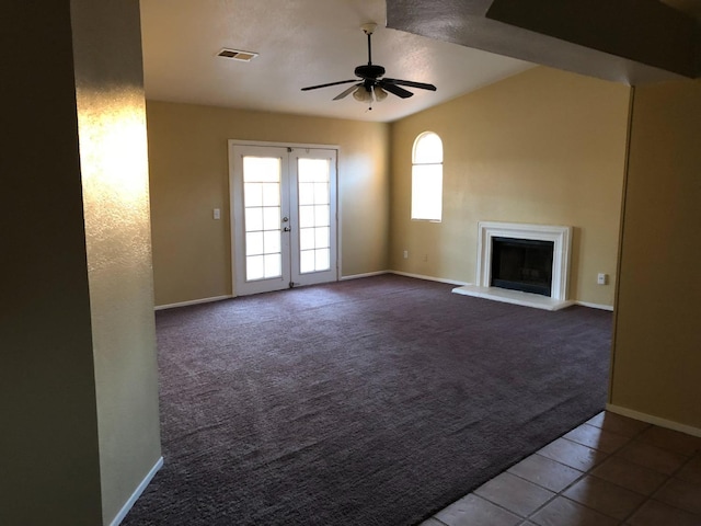 unfurnished living room with ceiling fan, french doors, and carpet floors