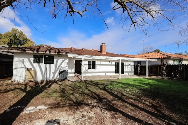 back of property featuring central air condition unit, a patio area, and a yard