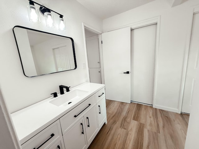 bathroom featuring hardwood / wood-style flooring and vanity