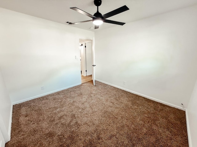 carpeted spare room with ceiling fan