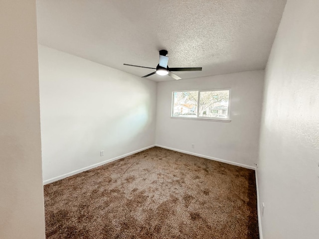 empty room with carpet, ceiling fan, and a textured ceiling