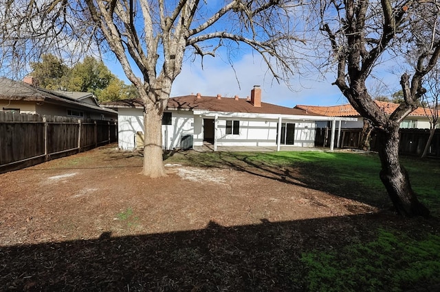 rear view of house with a lawn