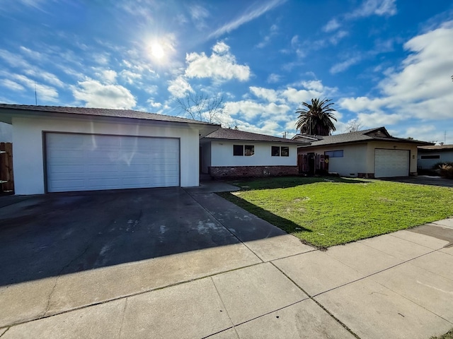 single story home featuring a garage and a front yard