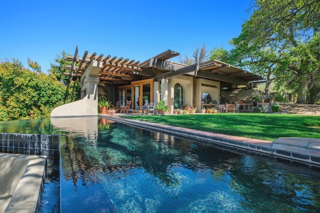 rear view of house with a pergola and a lawn