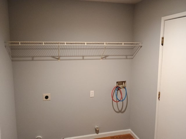 washroom featuring electric dryer hookup, gas dryer hookup, hookup for a washing machine, and hardwood / wood-style flooring