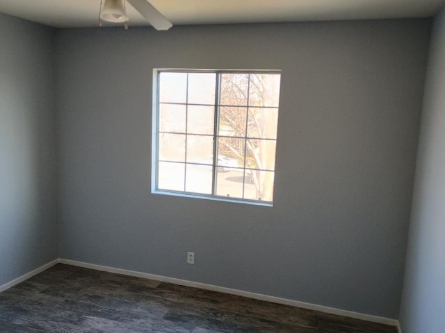 unfurnished room featuring a healthy amount of sunlight and dark hardwood / wood-style floors