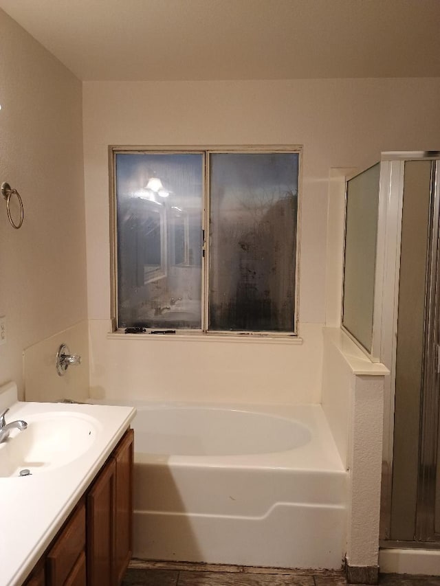 bathroom with vanity and separate shower and tub