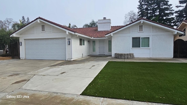 view of front of property with a front yard and a garage