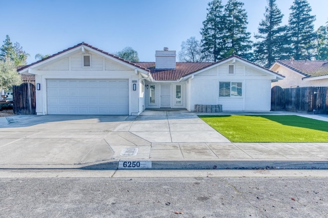 ranch-style home featuring a front yard and a garage