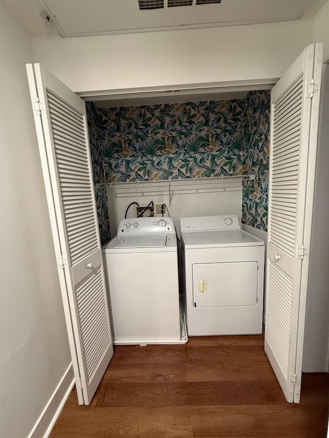 laundry room featuring dark hardwood / wood-style flooring and independent washer and dryer