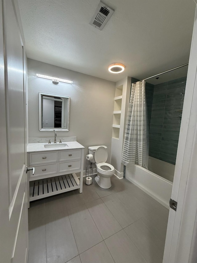 full bathroom featuring tile patterned floors, a textured ceiling, toilet, shower / bath combo with shower curtain, and vanity