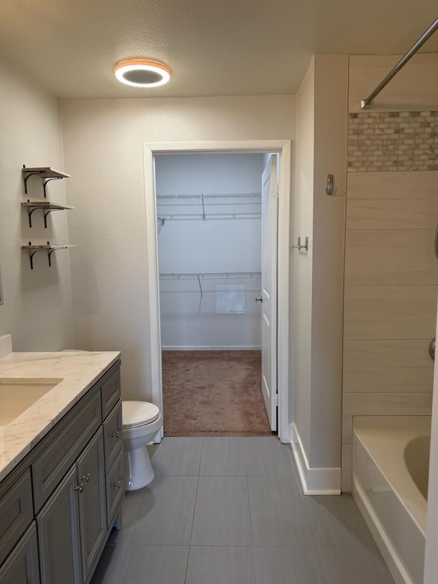 bathroom with tile patterned flooring, vanity, a textured ceiling, and toilet