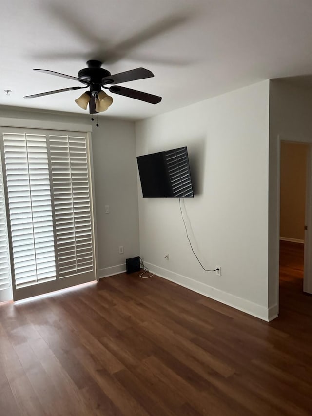 unfurnished room featuring ceiling fan and dark wood-type flooring